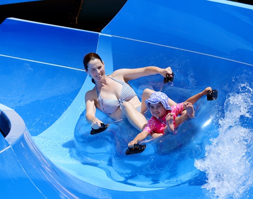 Visitors enjoying thrilling rides at ESCAPE Theme Park Penang, a popular tourist attraction in Malaysia