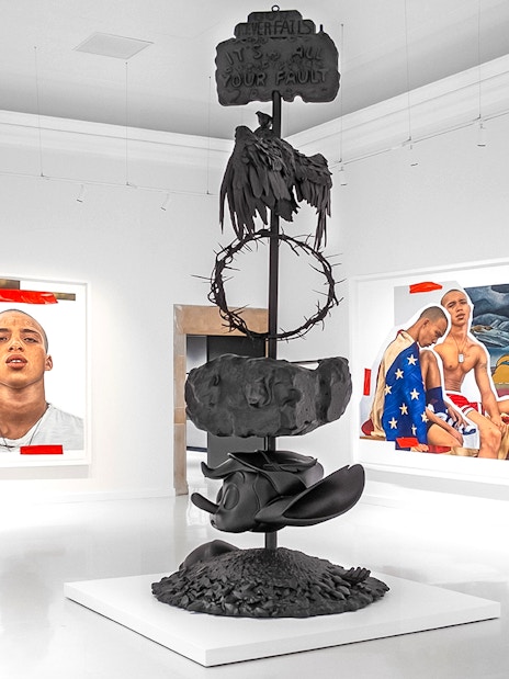 Modern art installation at Moco Museum Barcelona featuring sculptures and vibrant paintings.