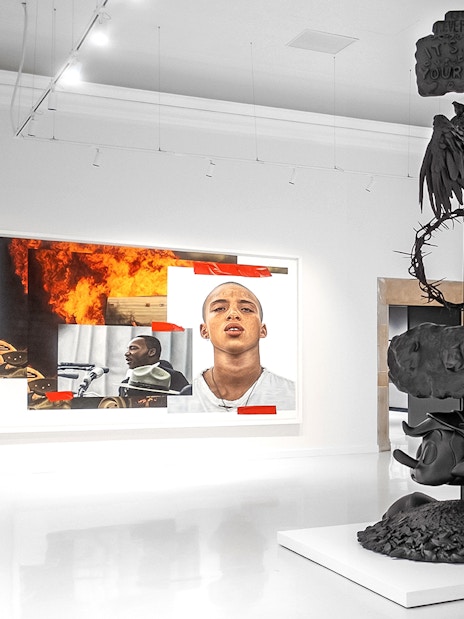 Modern art installation at Moco Museum Barcelona featuring sculptures and vibrant paintings.