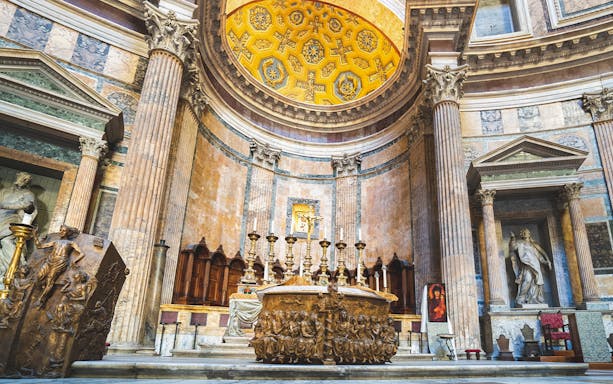 Pantheon interior with Altar of St. Paul, Rome, featuring ornate columns and religious sculptures.