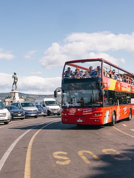 Open-top red bus on Florence Hop-On Hop-Off tour near Piazzale Michelangelo.