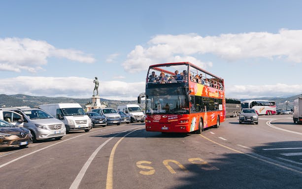 Open-top red bus on Florence Hop-On Hop-Off tour near Piazzale Michelangelo.