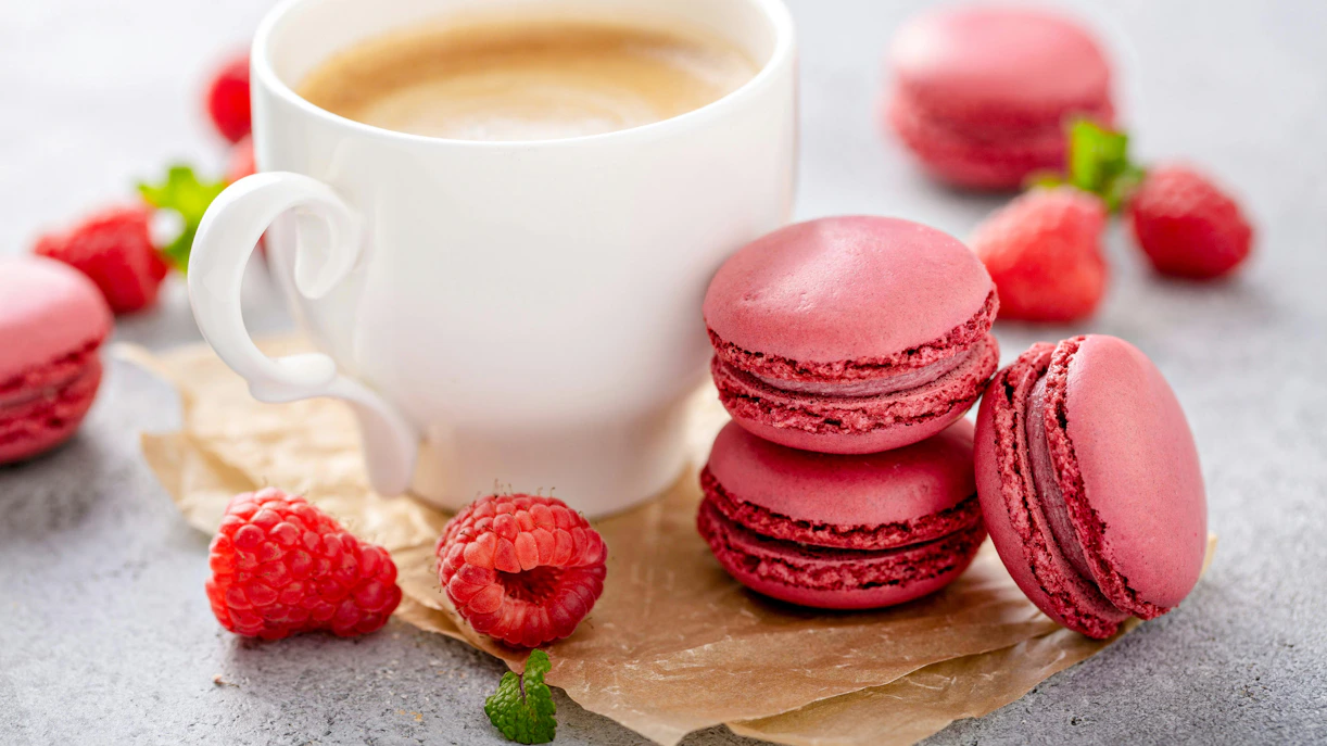 Raspberry macarons with coffee at a restaurant in Ibiza.