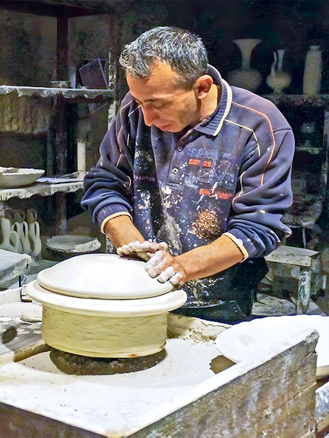 Potter crafting ceramics in Cappadocia workshop during 2-day private guided tour.