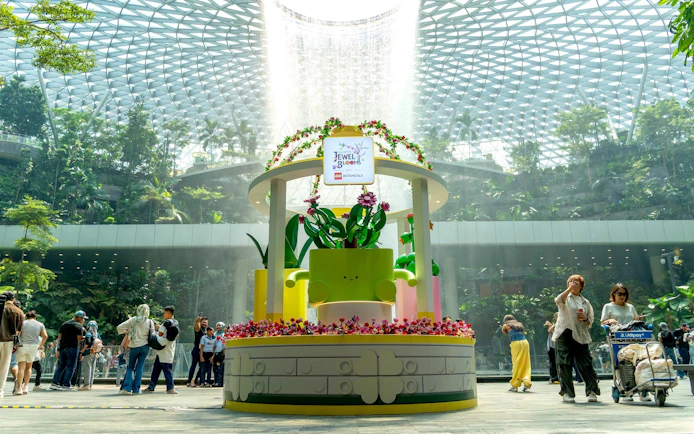 Jewel Changi Airport Canopy Park with floral display and visitors exploring.