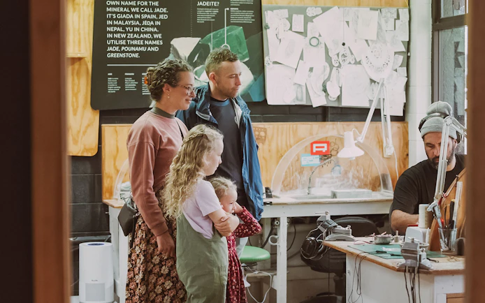 Family observing jade carving process on Mountain Jade Highlights Tour.