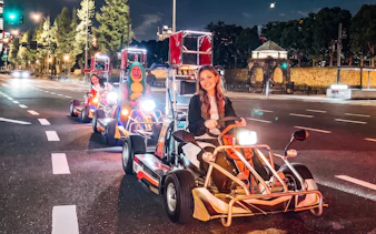 Go-karting on Shibuya streets with cityscape backdrop, part of NEO SHIBUYA EDGE experience.