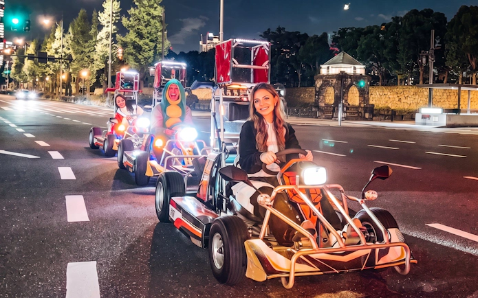 Go-karting on Shibuya streets with cityscape backdrop, part of NEO SHIBUYA EDGE experience.