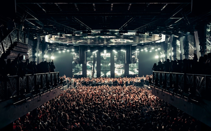 Black Coffee performing at UNVRS Ibiza with a large crowd and vibrant stage lights.