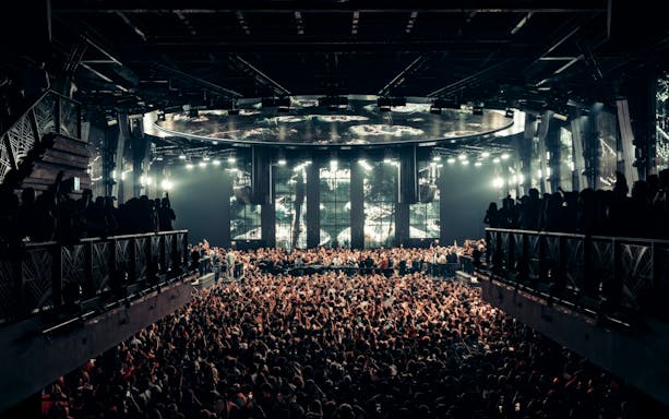 Black Coffee performing at UNVRS Ibiza with a large crowd and vibrant stage lights.