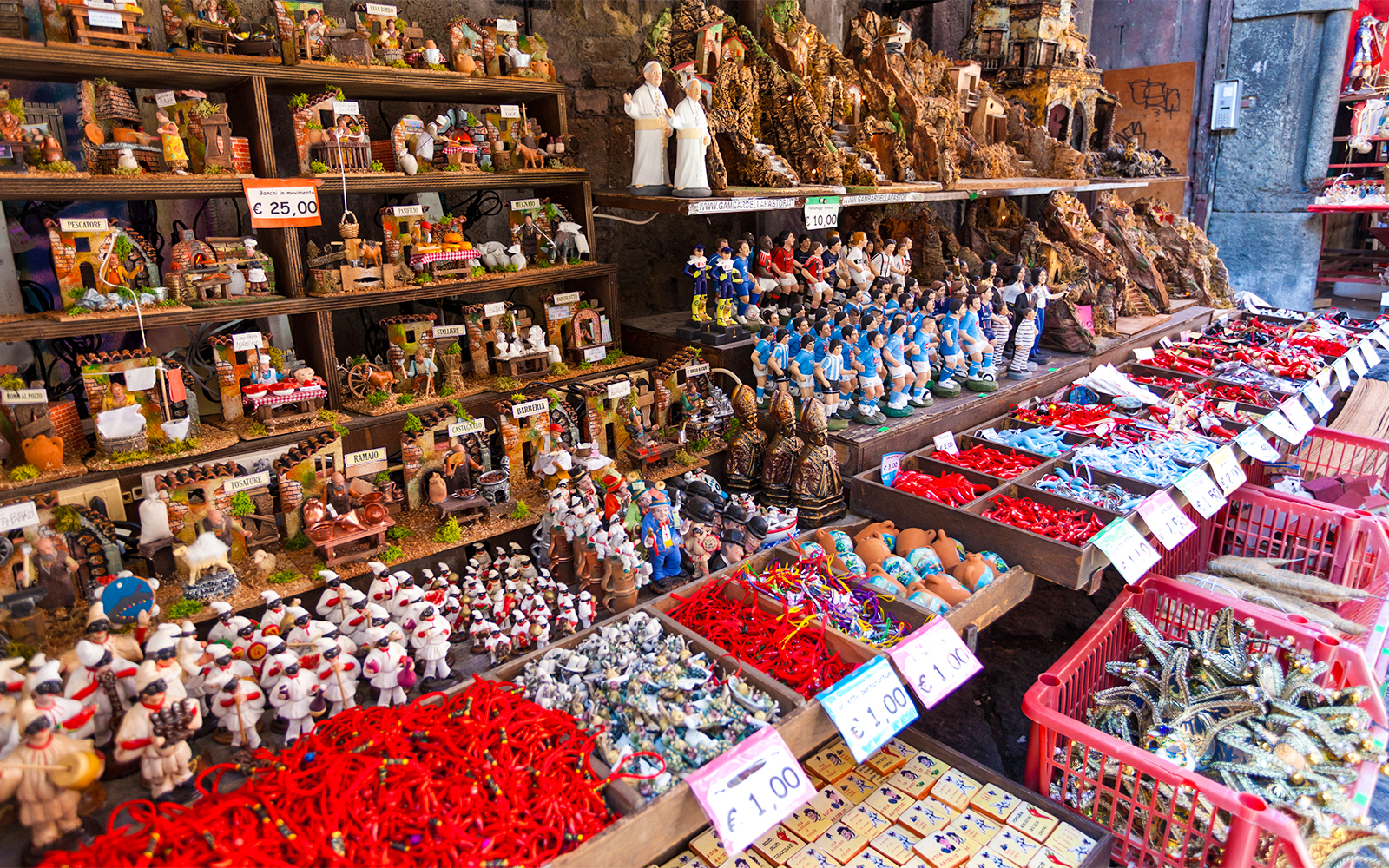 Nativity figurines and souvenirs displayed on San Gregorio Armeno street in Naples.