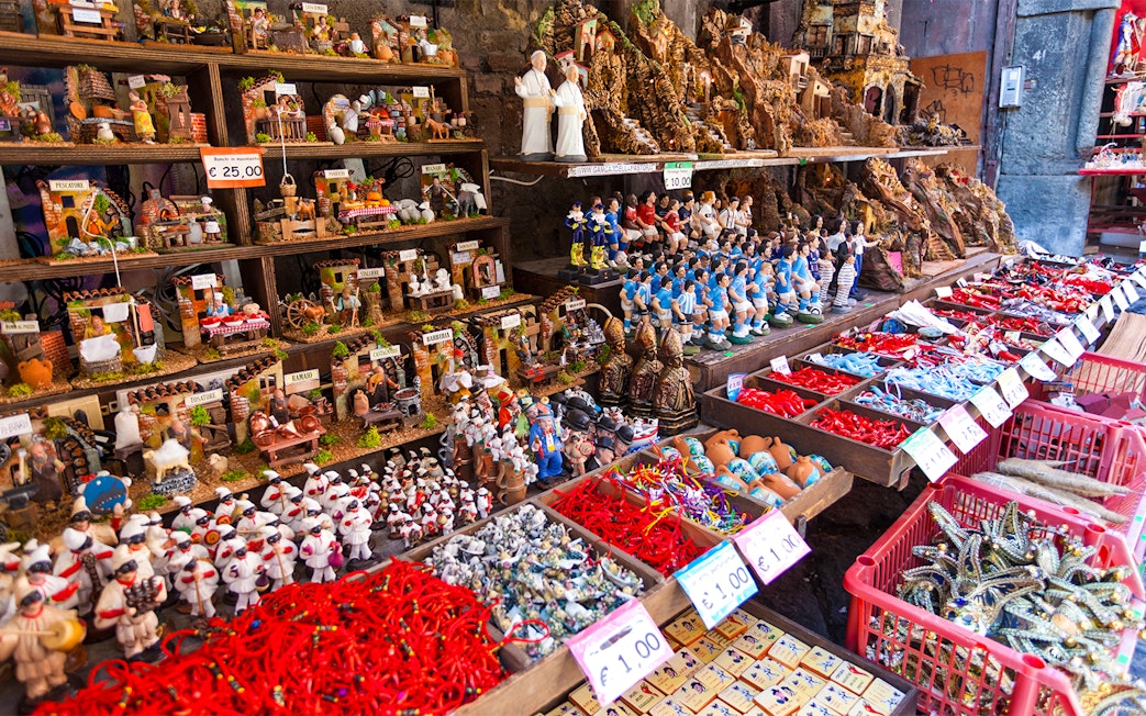 Nativity figurines and souvenirs displayed on San Gregorio Armeno street in Naples.