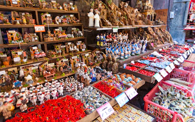 Nativity figurines and souvenirs displayed on San Gregorio Armeno street in Naples.