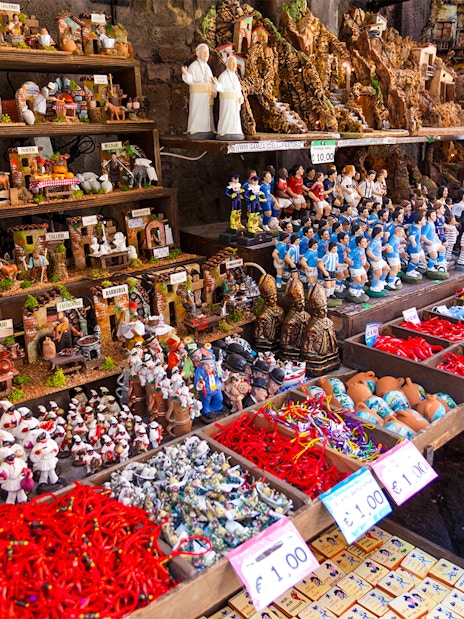 Nativity figurines and souvenirs displayed on San Gregorio Armeno street in Naples.