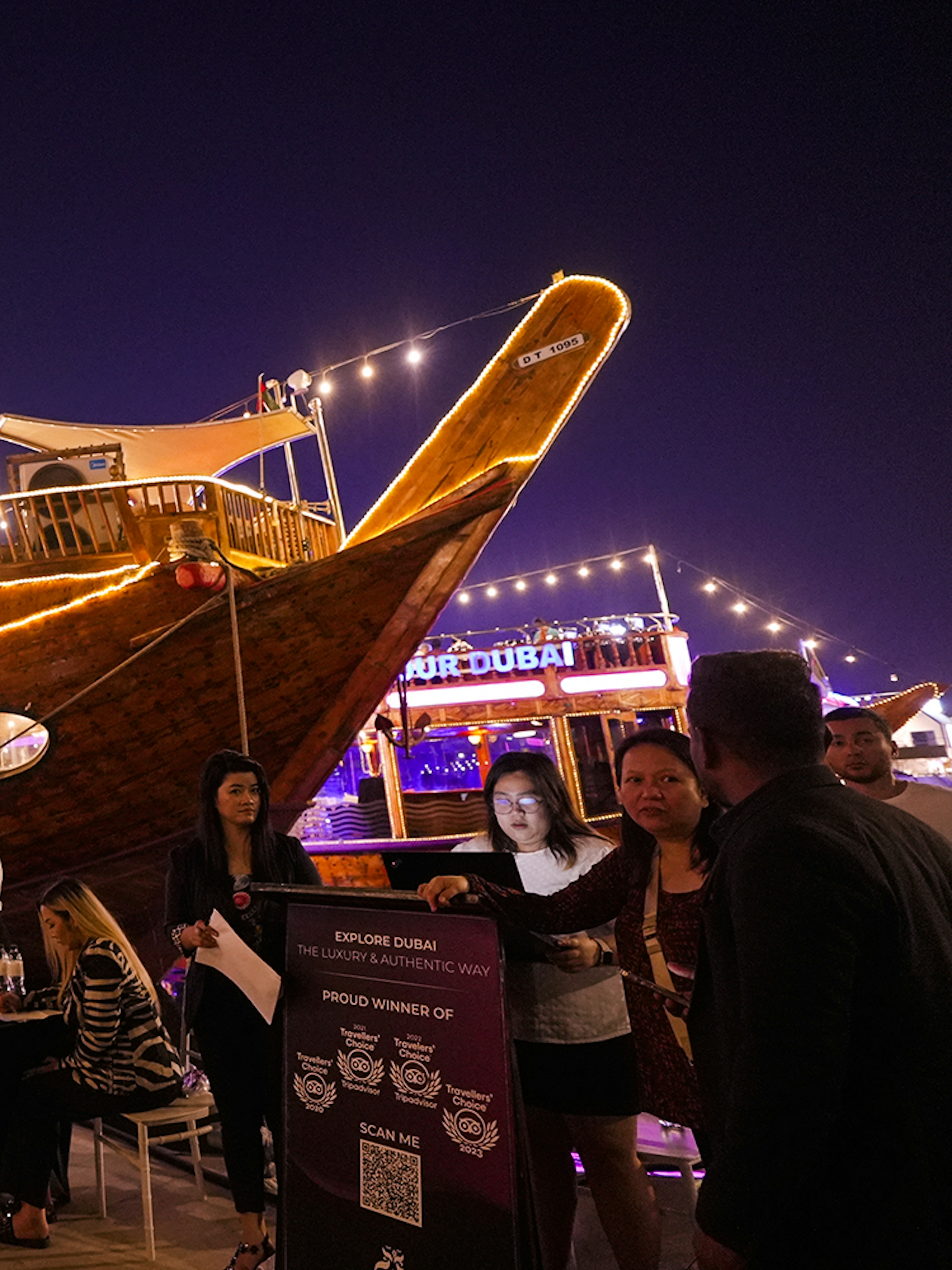 Dubai Marina dhow cruise with guests boarding for a 5-star Indian dinner experience.