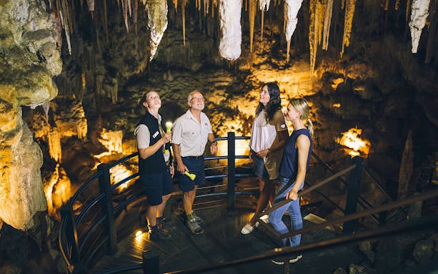 Visitors exploring stalactites on a Semi-Guided Ngilgi Cave Tour.