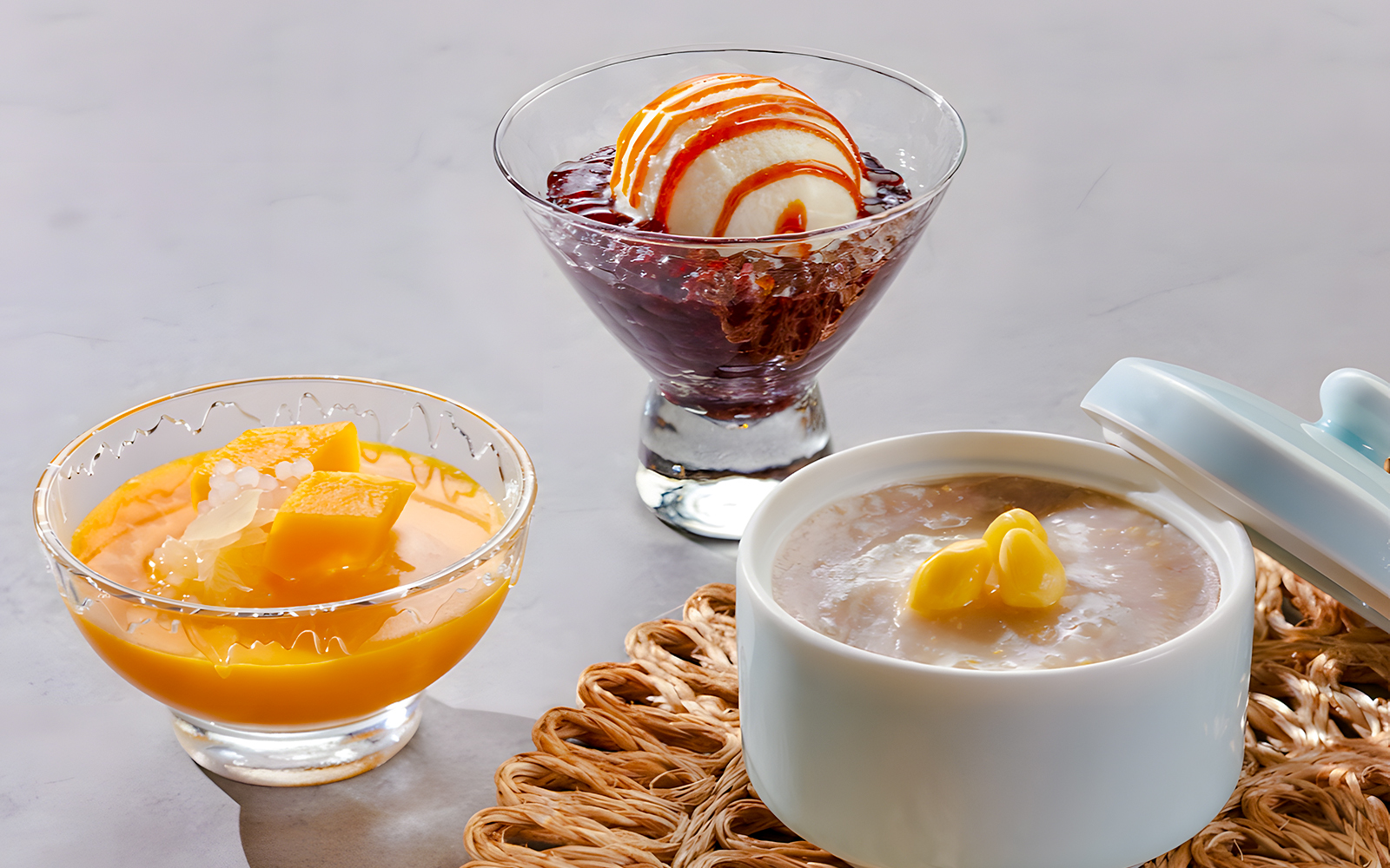 Desserts at House of Seafood, Clarke Quay, Singapore featuring mango pudding, ice cream with red bean, and sweet soup.