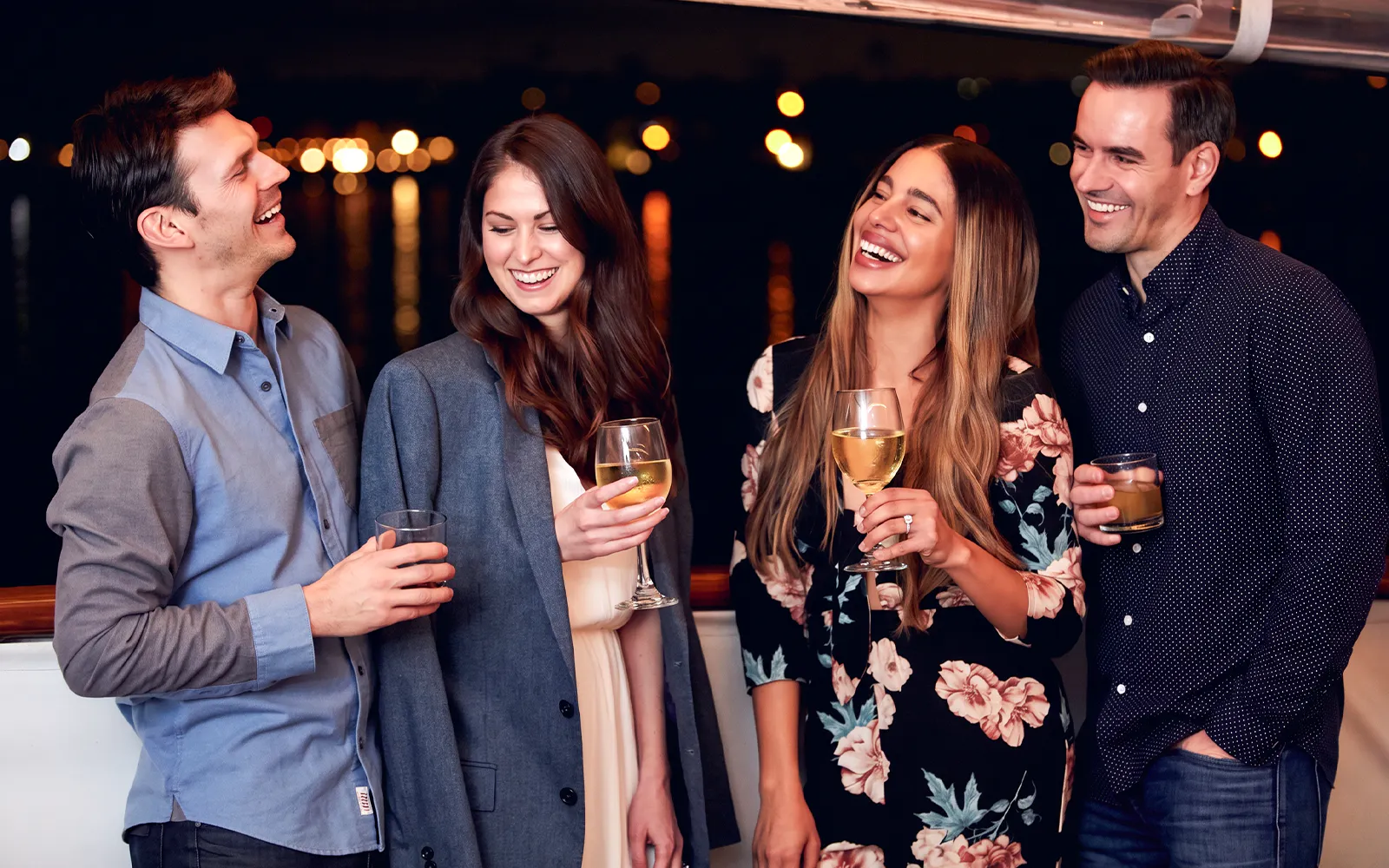 Guests enjoying drinks on the Marina del Rey Premier Dinner Cruise at night.
