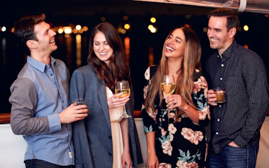 Guests enjoying drinks on the Marina del Rey Premier Dinner Cruise at night.