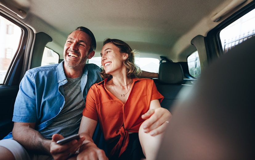 Couple enjoying private airport transfer in Dubai car.