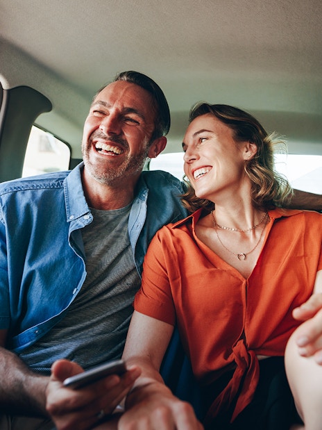 Couple enjoying private airport transfer in Dubai car.