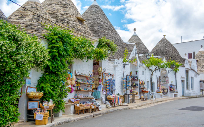 Trulli houses with souvenir shops in Alberobello, Puglia, Italy.