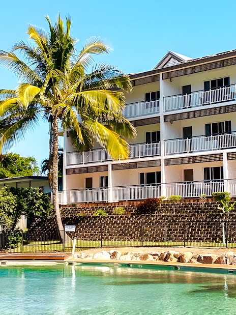 K'gari Beach Resort pool area with palm trees, Fraser Island.