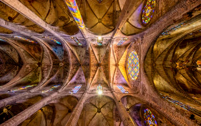 Ceiling view of Santa Maria de Majorica's gothic cathedral in Palma with stained glass windows.