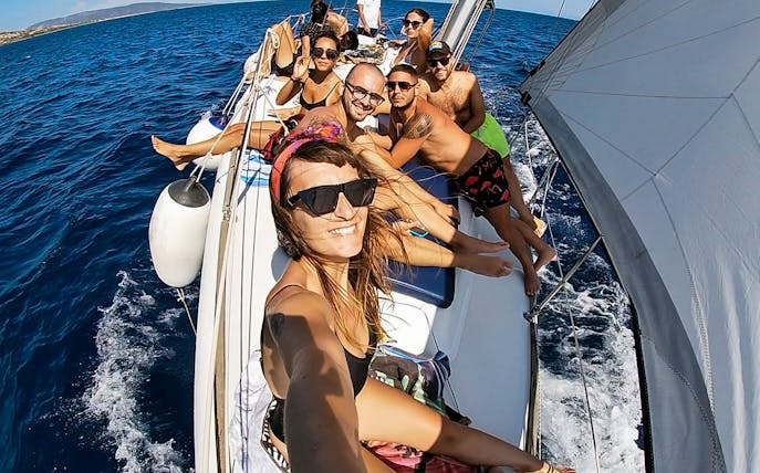 Group enjoying sailboat excursion to Asinara National Park from Stintino.