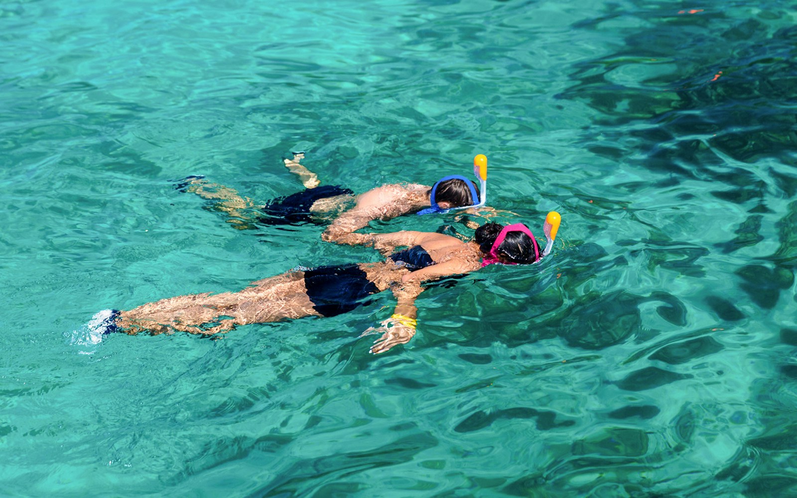 Tourists snorkeling in clear waters at Surin Island, Thailand.