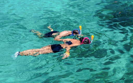Tourists snorkeling in clear waters at Surin Island, Thailand.