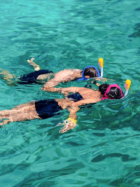 Tourists snorkeling in clear waters at Surin Island, Thailand.