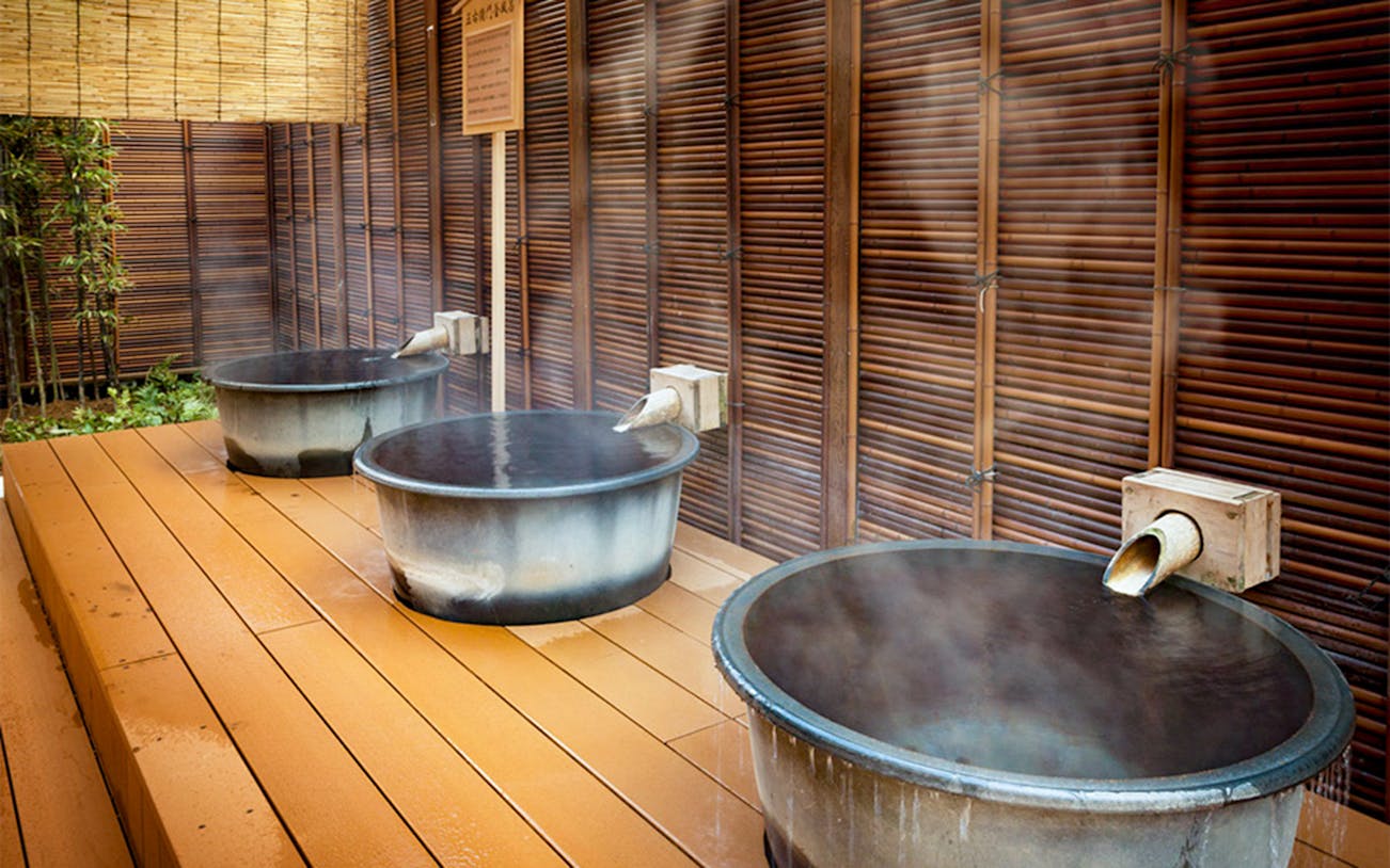 Hot water filling tubs at Arima Onsen Taikou-no-yu Spa in Japan.