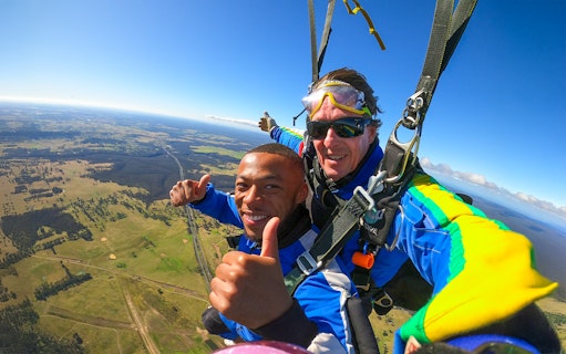 Tandem skydive over Sydney with scenic landscape view, part of city transfer tour.