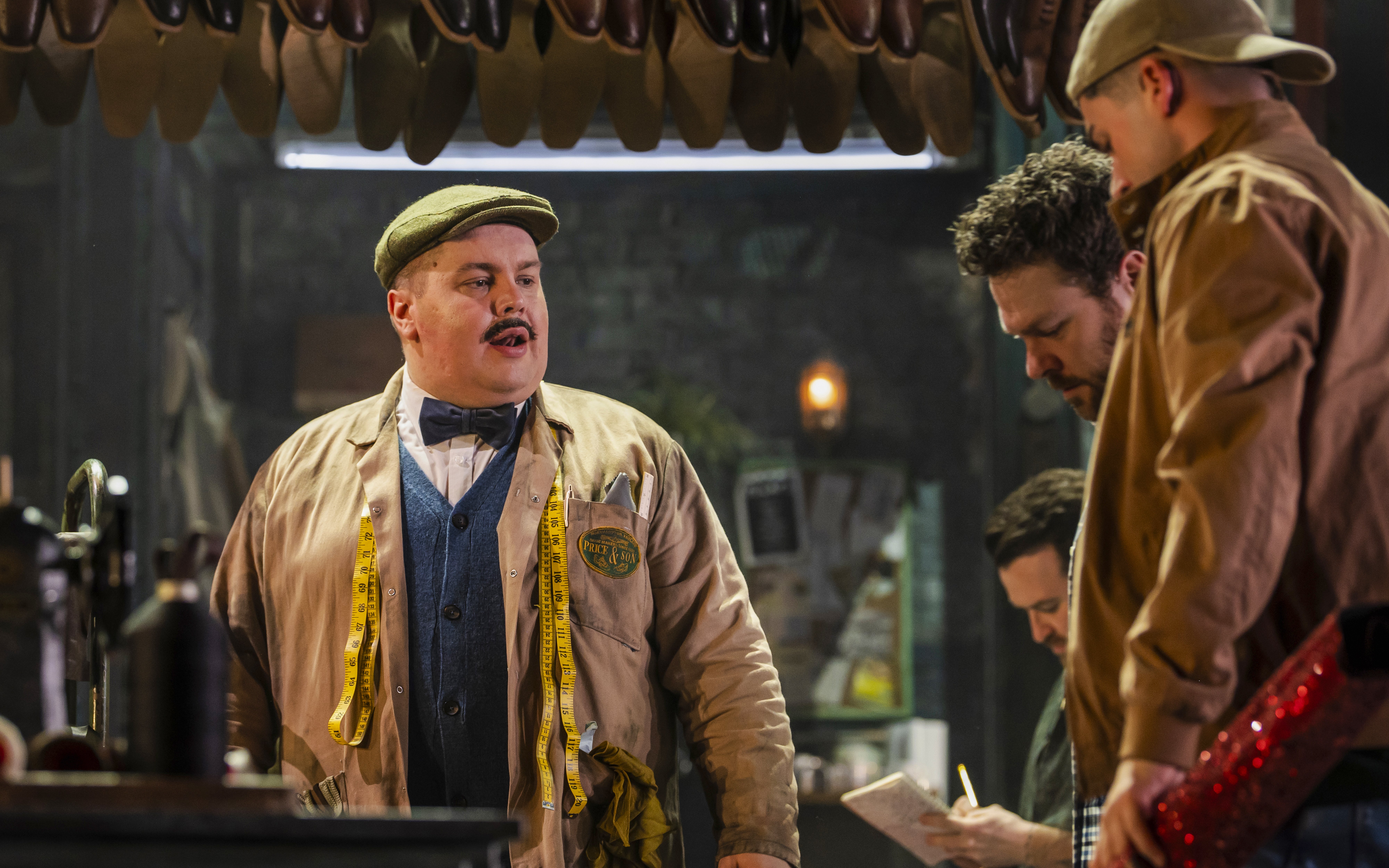 Characters in a shoe factory scene from Kinky Boots production.