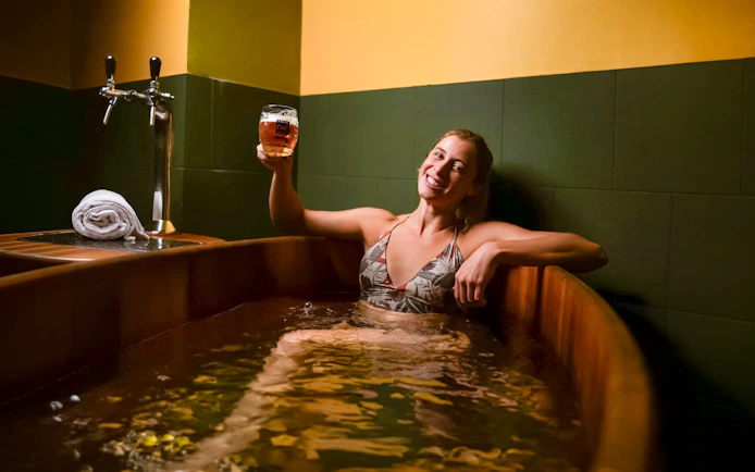 Person enjoying a beer spa at Lukács Thermal Bath in Budapest.