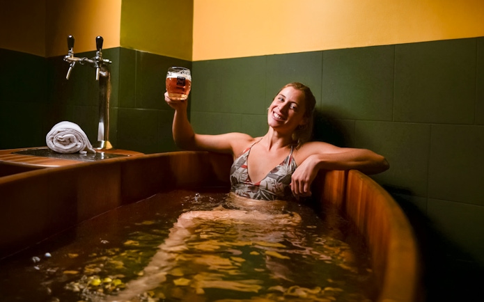 Person enjoying a beer spa at Lukács Thermal Bath in Budapest.