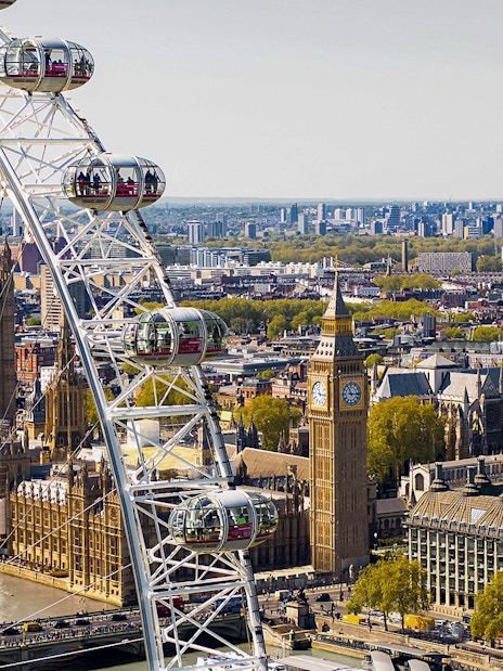 London Eye overlooking Big Ben and the Houses of Parliament, view from Thames River.