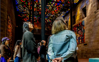 Visitors observing stained glass ceiling at National Gallery of Victoria during Best of NGV Experiences Tour.