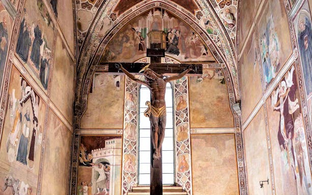 Crucifix and frescoes inside Museum of Brunello di Montalcino, Italy.