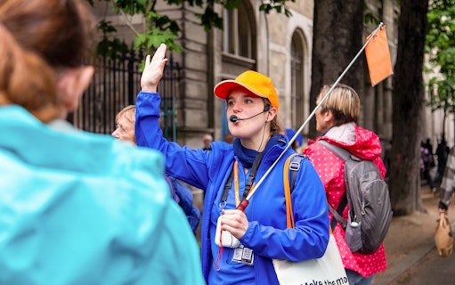 Tour guide leading a group on the Notre Dame de Paris walking tour with crypt entry.