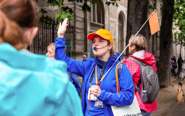 Tour guide leading a group on the Notre Dame de Paris walking tour with crypt entry.