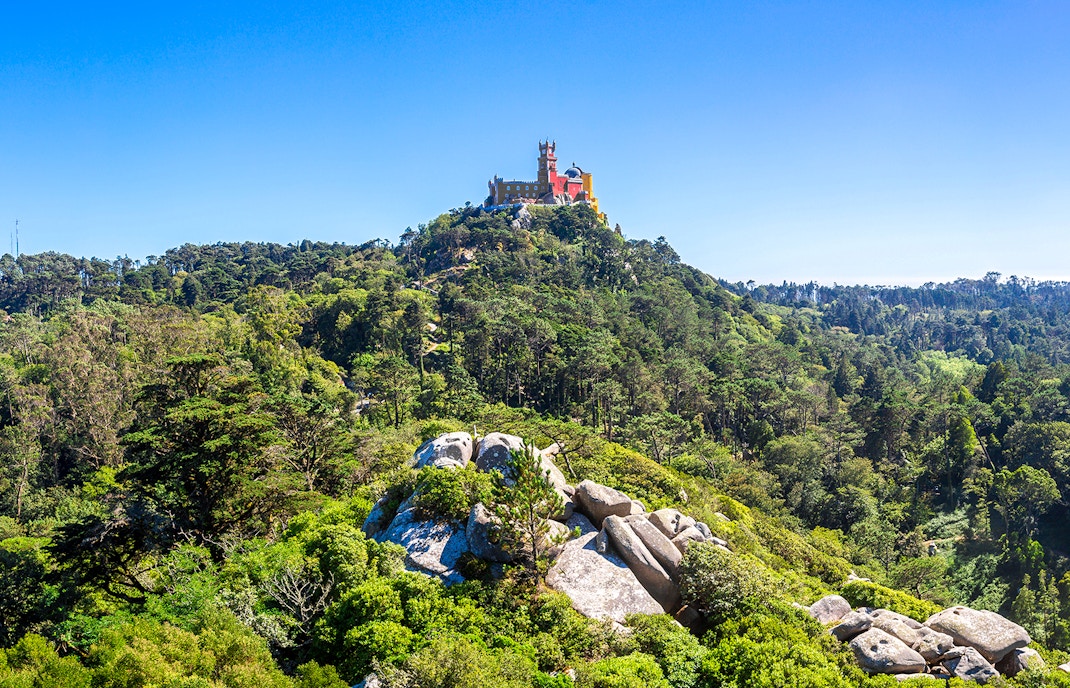 Pena Palace Park in Sintra with colorful palace towers and lush green gardens.