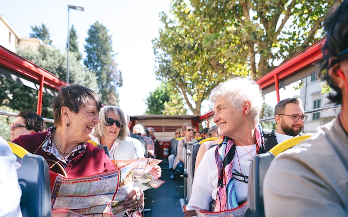 Passengers enjoying City Sightseeing Turin hop-on hop-off bus tour.