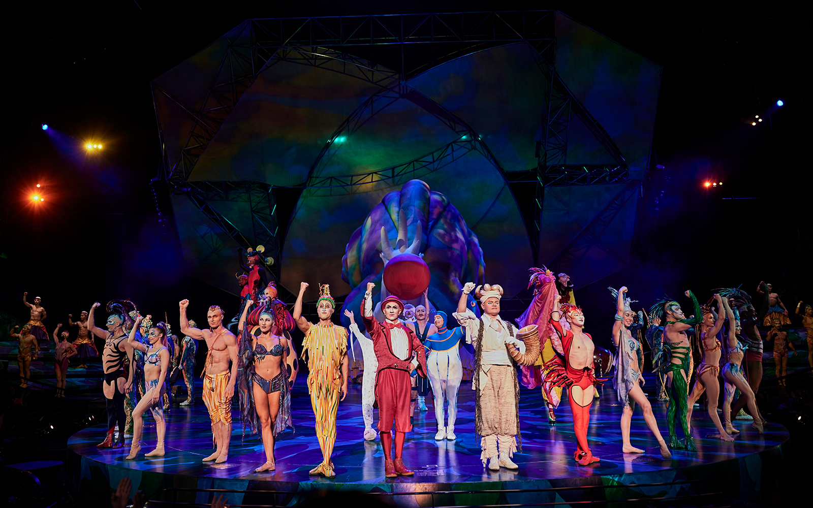 Performers in colorful costumes on stage during Mystère show.