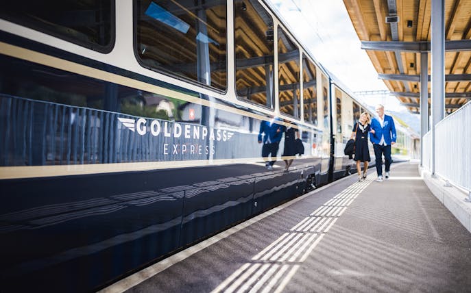 GoldenPass Express train at station platform in Interlaken, Switzerland.