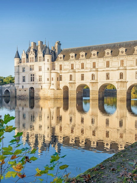 Château de Chenonceau exterior with arches over the Cher River, France.