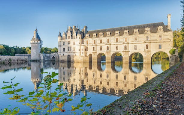 Château de Chenonceau exterior with arches over the Cher River, France.