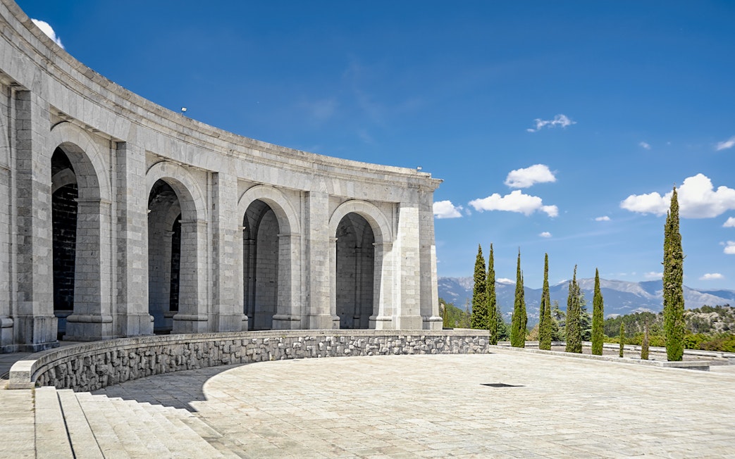 Monument arches at Valley of the Fallen, Spain, with mountain view.