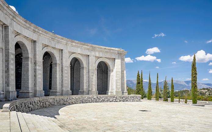 Monument arches at Valley of the Fallen, Spain, with mountain view.